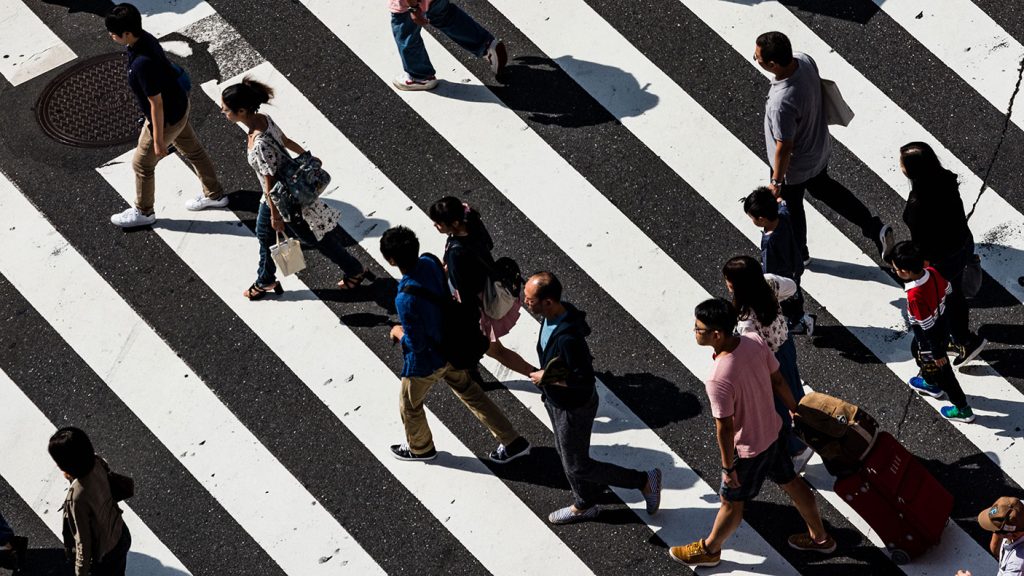 People passing a cross over in Tokyo