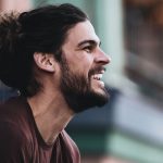 Profile of smiling Male with man-bun